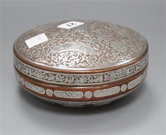 A 19th century Cairo ware silver overlaid copper box and cover Diameter 17cm. approx.